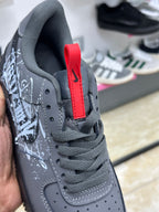 Nike Air Force 1 black white graffiti-style graphic splatter design